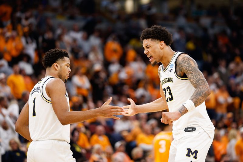 Mar 29, 2026; Chicago, IL, USA; Michigan Wolverines forward Yaxel Lendeborg (23) celebrates with guard Trey McKenney (1) in the first half against the Tennessee Volunteers during an Elite Eight game of the Midwest Regional of the men's 2026 NCAA Tournament at United Center. Mandatory Credit: Kamil Krzaczynski-Imagn Images
