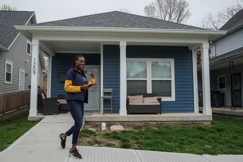 Indiana Senate District 46 candidate Allissa Impink walks away from a house Wednesday, April 1, 2026, while door-knocking near Pride Park in Indianapolis.