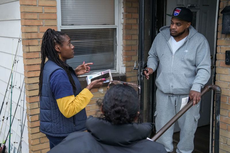 Indiana Senate District 46 candidate Allissa Impink speaks with community member Brent Holiman on Wednesday, April 1, 2026, while door-knocking near Pride Park in Indianapolis.