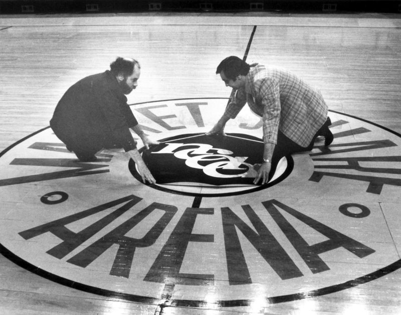 Sports Moments in Indiana Century Larry Taylor (left) and Ed Grover of the Market Square Arena staff put the NCAA logo on the basketball court in preparation for the 1980 Final Four. Purdue Iowa UCLA and eventual champions Louisville battled for the title. News staff photo by Bob Doeppers March 20 1980.