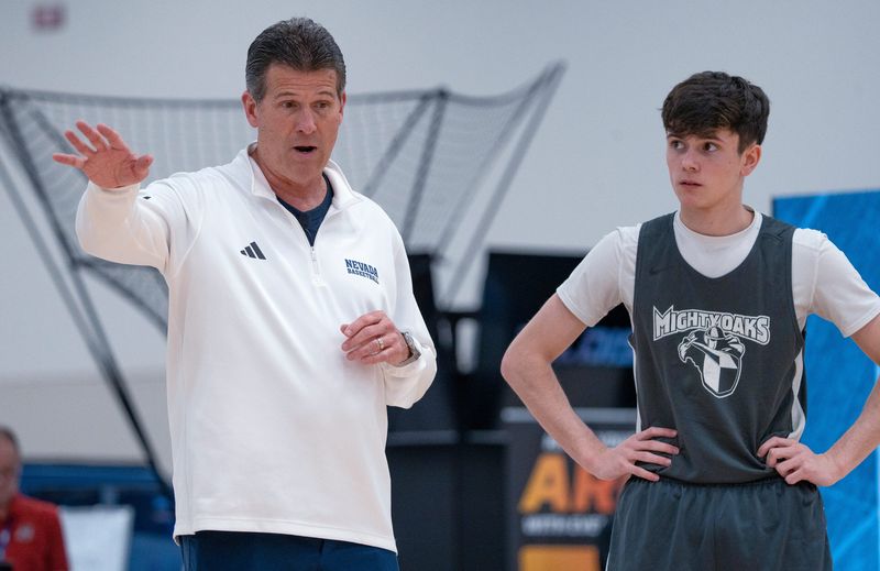 Steve Alford, left, teaches shooting techniques as he works with Isaac Meddings, from the Oakland City University basketball team, during a clinic put on by the National Association of Basketball Coaches, Friday, April 3, 2026 at the Indiana Convention Center.