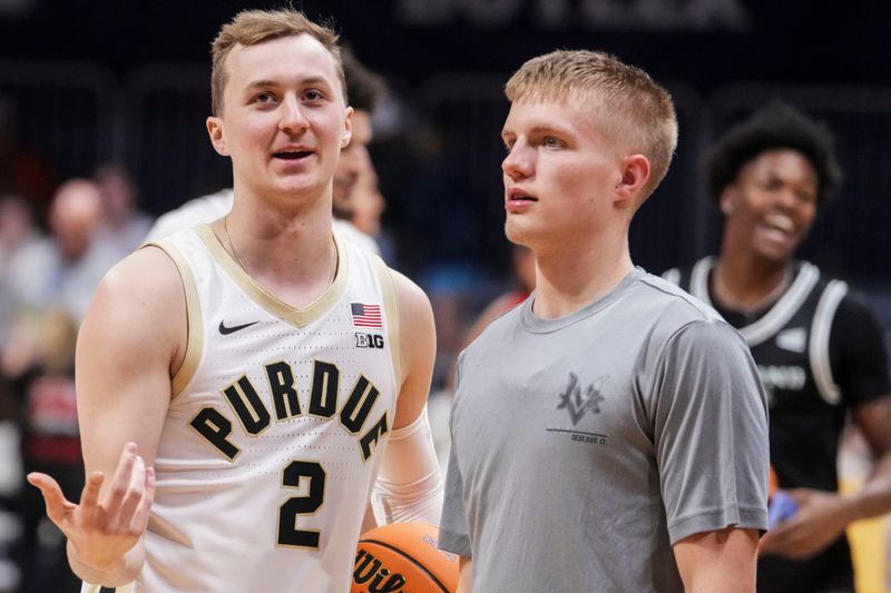 Purdue’s Fletcher Loyer and Mt. Vernon’s Luke Ertel talk Friday, April 3, 2026, during the State Farm College Slam Dunk and 3-Point Championships at Hinkle Fieldhouse in Indianapolis.