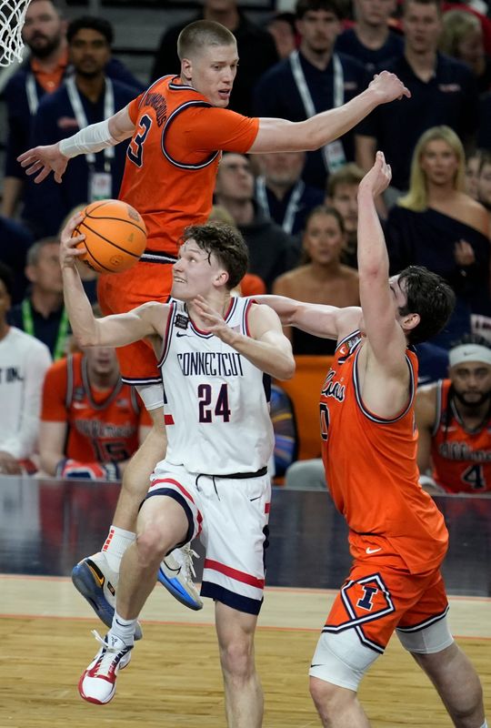 UConn Huskies guard Braylon Mullins (24) drives past a host of Illinois Fighting Illini defenders Saturday, April 4, 2026, during a Final Four game at Lucas Oil Stadium in Indianapolis.