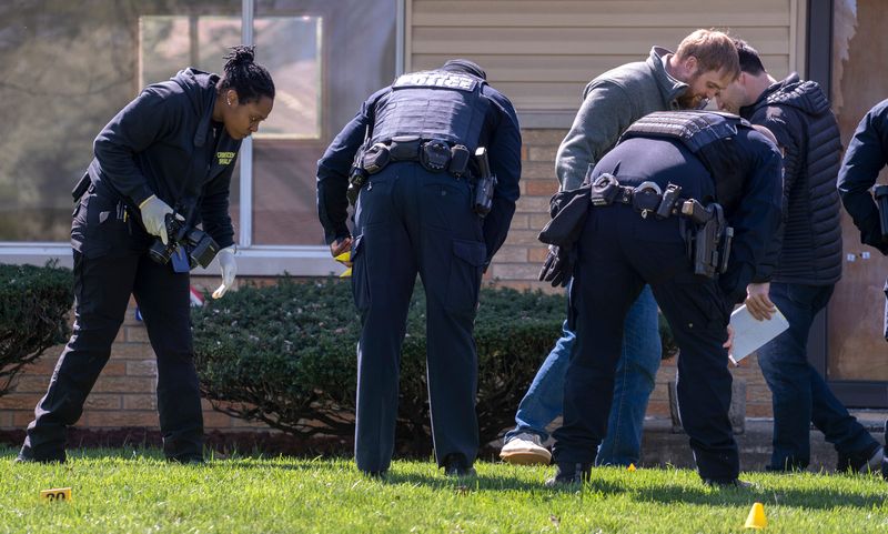Investigators study the scene Monday, April 6, 2026 in the 5000 block of E. 41st St. of an early morning shooting. The home of City-County Councilman Ron Gibson was shot at in the early morning. Less than a week before, the councilor had publicly supported a Martindale Brightwood data center. A “No Data Centers” note was tucked under his doormat at the time of the incident.