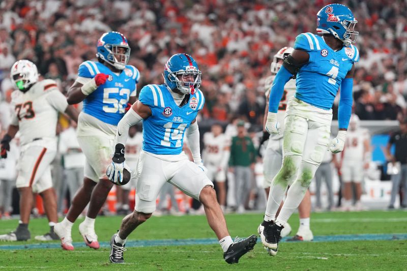 Jan 8, 2026; Glendale, AZ, USA; Mississippi Rebels safety Kapena Gushiken (14) reacts after making an interception against the Miami Hurricanes in the second half during the 2026 Fiesta Bowl and semifinal game of the College Football Playoff at State Farm Stadium. Mandatory Credit: Joe Camporeale-Imagn Images