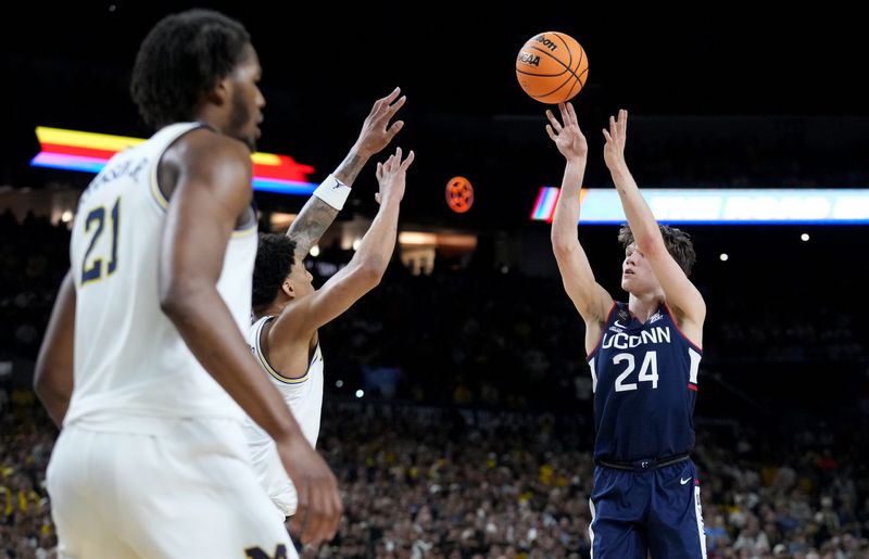 UConn Huskies guard Braylon Mullins (24) shoots Monday, April 6, 2026, during the NCAA men's basketball tournament national championship game against the Michigan Wolverines at Lucas Oil Stadium in Indianapolis.