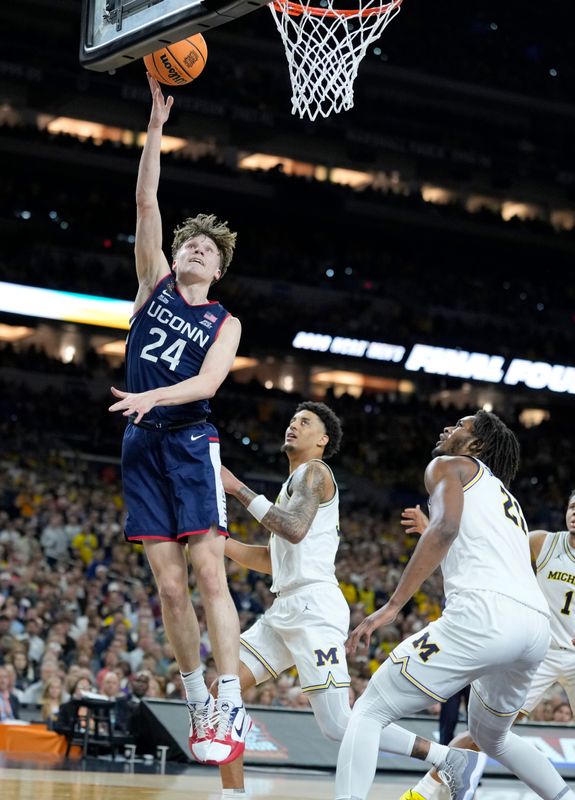UConn Huskies guard Braylon Mullins (24) goes up for a layup Monday, April 6, 2026, against the Michigan Wolverines during the NCAA men's basketball tournament national championship game at Lucas Oil Stadium in Indianapolis.