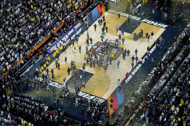 Confetti falls Monday, April 6, 2026, as the Michigan Wolverines celebrate their NCAA men's basketball tournament national championship victory after defeating the UConn Huskies 69-63 at Lucas Oil Stadium in Indianapolis.