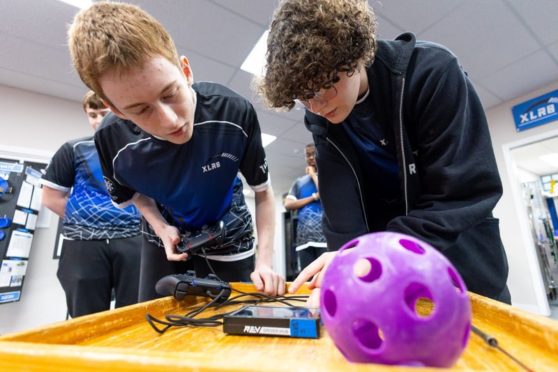 Zach Stutzman, 17, and Alexa Wickline, 15, work on making programing adjustments during an XLR8 Robotics practice Tuesday, March 31, 2026, at GEARS Youth Robotics Center in Osceola.