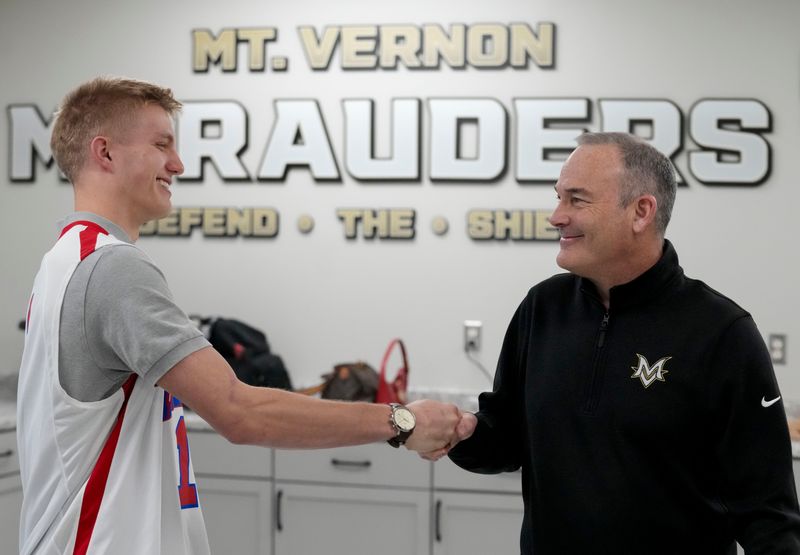 Mt. Vernon head basketball coach Joe Bradburn (right) shakes hands ith Luke Ertel (left) after Ertel is named Mr. Basketball on Thursday, April 9, 2026, at Mt. Vernon High School in Fortville.