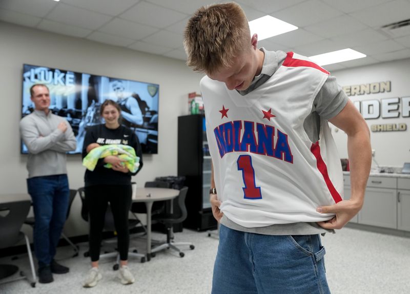 Luke Ertel puts on a jersey after he is named Mr. Basketball on Thursday, April 9, 2026, at Mt. Vernon High School in Fortville.