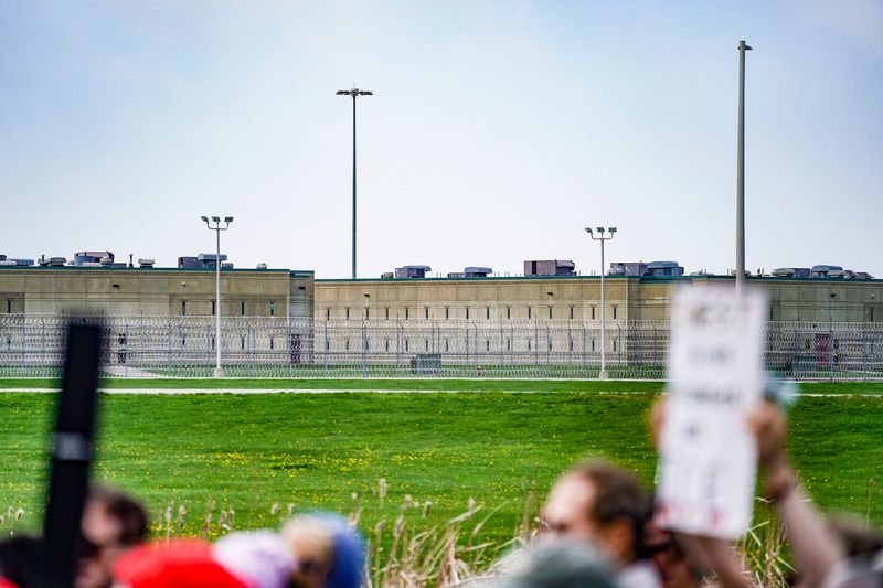 Protesters hold signs during a press conference with political and faith leaders at Miami Correctional Facility on Thursday, April 9, 2026, in Bunker Hill, Indiana.