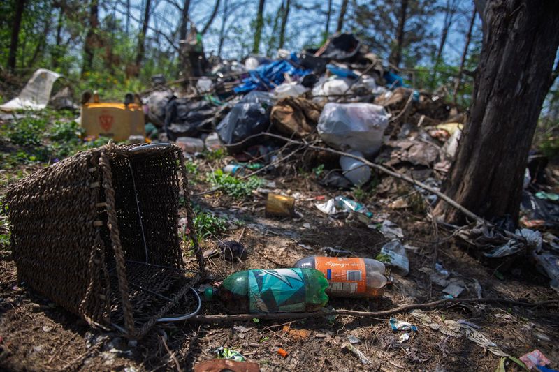Two-liter bottles among the debris piled up in Browns Woods from a homeless camp that had been recently evicted on Thursday, April 9, 2026.