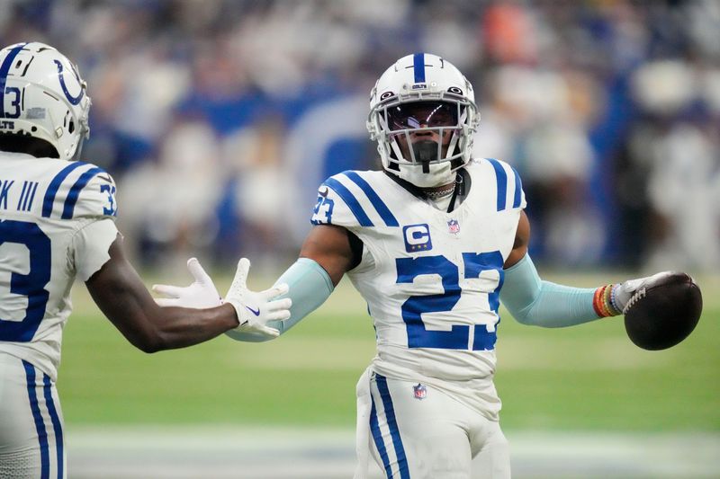 Indianapolis Colts cornerback Kenny Moore II (23) high fives Indianapolis Colts cornerback Samuel Womack III (33) after making an interception at the end of the game Sunday, Dec. 22, 2024, during a game against the Tennessee Titans at Lucas Oil Stadium in Indianapolis.