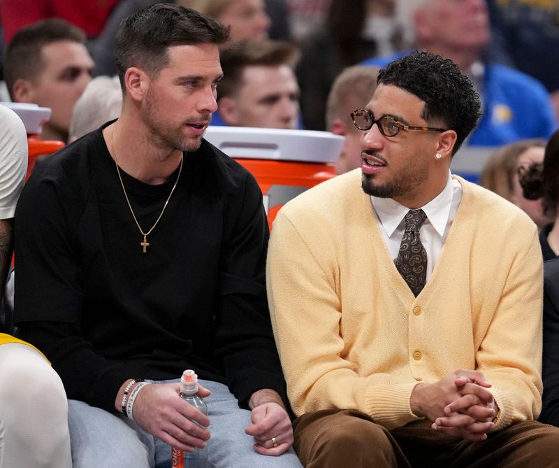 Indiana Pacers guard T.J. McConnell (9) and guard Tyrese Haliburton (0) speak on the bench during a game against the Philadelphia 76ers on Friday, April 10, 2026, at Gainbridge Fieldhouse in Indianapolis.