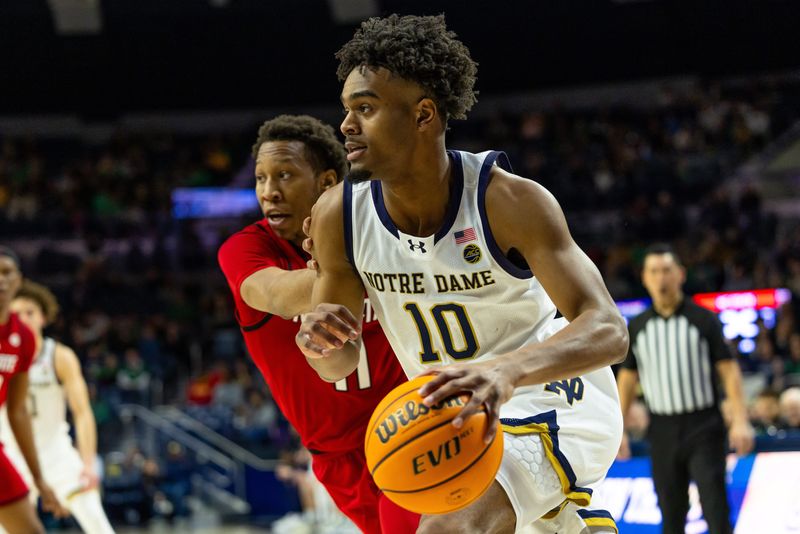Feb 28, 2026; South Bend, Indiana, USA; Notre Dame Fighting Irish forward Jalen Haralson (10) drives as NC State Wolfpack guard Quadir Copeland (11) defends during the first half at Purcell Pavilion at the Joyce Center. Mandatory Credit: Michael Caterina-Imagn Images