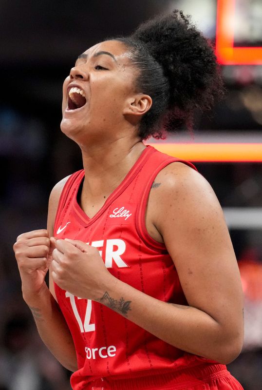 Indiana Fever center Damiris Dantas (12) reacts after she shoots and scores against the Washington Mystics during the second half of a game Friday, Aug. 15, 2025, at Gainbridge Fieldhouse in Indianapolis. The Fever fell to the Mystics 88-84.