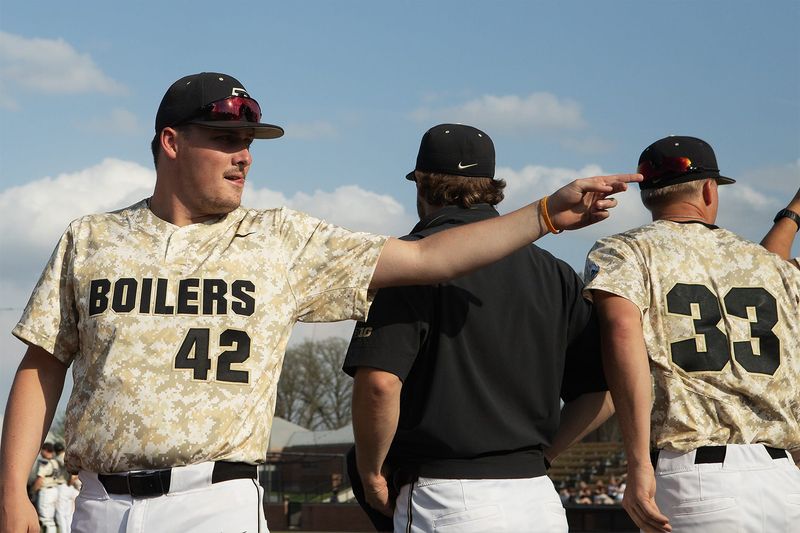 Purdue redshirt sophomore right-handed pitcher Thomas Howard, left, lines up before the game start on Tuesday, April 14, 2026, at Alexander Field in West Lafayette, Ind.