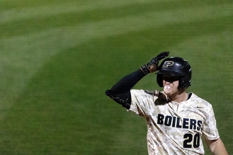 Purdue redshirt senior Aaron Manias blows a bubble from gum while lining up to bat on Tuesday, April 14, 2026, at Alexander Field in West Lafayette, Ind. Manias appeared at bat once during the game.