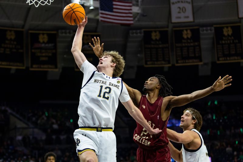 Jan 24, 2026; South Bend, Indiana, USA; Notre Dame Fighting Irish forward Garrett Sundra (12) fights for a rebound with Boston College Eagles guard Aidan Shaw (23) during the second half at Purcell Pavilion at the Joyce Center. Mandatory Credit: Michael Caterina-Imagn Images