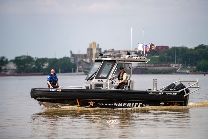 Evansville Police Sgt. Mike Saltzman, left, and Vanderburgh County Sheriff's Sgt. Chad Howard launch the new Joint River Patrol Unit boat River Wolf in the Ohio River after a christening at Dress Plaza in Evansville, Ind., Friday, April 17, 2026.