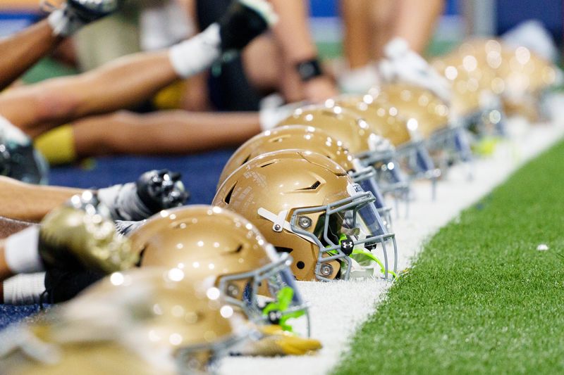 Helmets form a line down the field as players warm up during a Notre Dame football practice at Irish Athletic Center on Saturday, April 18, 2026, in South Bend.