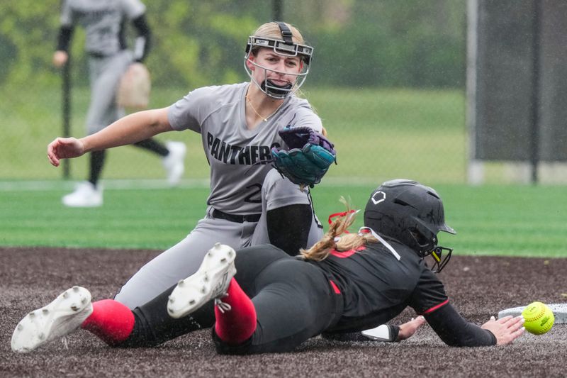 Western second baseman Brynley Erb (22) attempts to catch the ball against Center Grove outfielder Erica Burris (3) on Saturday, April 18, 2026, during a game at Center Grove High School in Greenwood, Ind. Center Grove defeated Western, 15-2, in five innings.