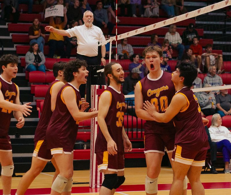 Bloomington North's boys volleyball team celebrates with Riley Thackery (30) after he scored a point against Bloomington South in their boys volleyball match at Wilkinson Hall on Monday, April 20, 2026.