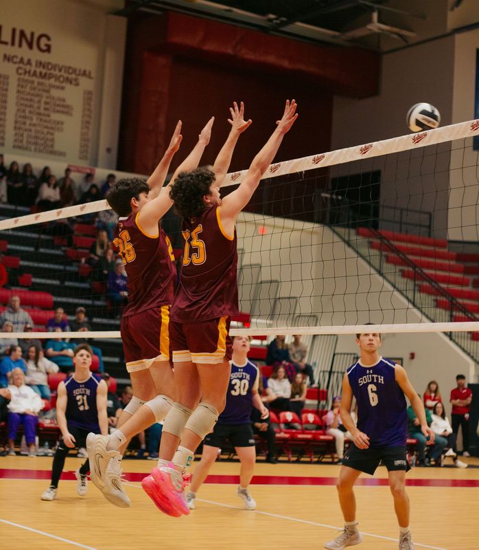 Bloomington North's Ramsey Mills and Gavin Hodgson go up for the block against Bloomington South in their boys volleyball match at Wilkinson Hall on Monday, April 20, 2026.