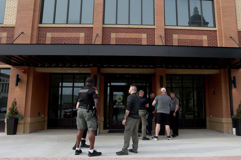 People chat outside after the Clinton County Sherriff Merit Board meets on Wednesday, April 15, 2026, at the Clinton County Annex in Frankfort, Ind.
