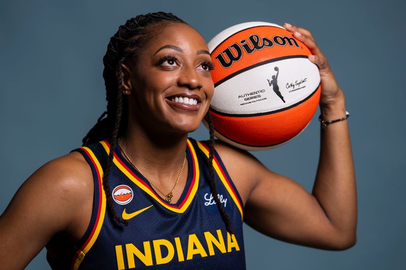 Indiana Fever guard Kelsey Mitchell (0) poses for a photo Wednesday, April 22, 2026, during media day at Gainbridge Fieldhouse in Indianapolis.