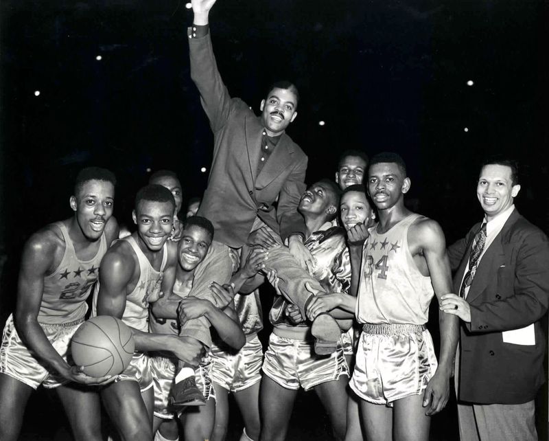 Feb. 27, 1954; Indianapolis, Indiana, USA; Crispus Attucks players, including Oscar Robertson (second from left) celebrate after winning the sectional title game 53-46 over Tech by hoisting Coach Ray Crowe on their shoulders at Butler Fieldhouse. Mandatory Credit: Maurice G. Burnett/Indianapolis Star-USA TODAY NETWORK