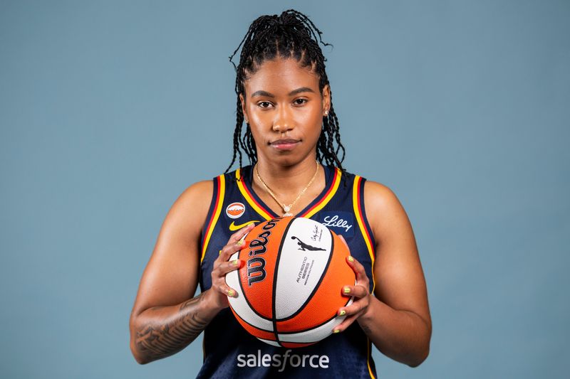 Indiana Fever guard Tyasha Harris (52) poses for a photo Wednesday, April 22, 2026, during media day at Gainbridge Fieldhouse in Indianapolis.