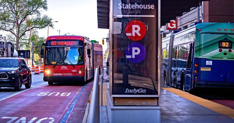 IndyGo buses travel by the Indiana Statehouse on Capitol Ave., Thursday, April 23, 2026 in downtown Indianapolis. With gas prices rising, some are taking alternative modes of transportation.