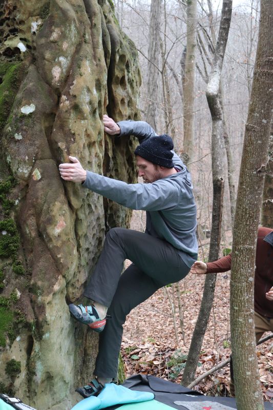 Dylan Kehres, the vice president of the Indiana Climbers Coalition, climbs a cliff at Buff Boulders in Hoosier National Forest.
