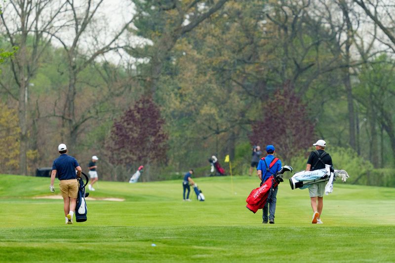 Players walk to their next shot during the Adams High School Invitational at Morris Park Country Club on Friday, April 24, 2026, in South Bend.