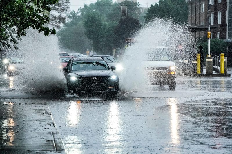 Motorists drive through flooded streets after severe weather moved through on Thursday, April 23, 2026, in Indianapolis.