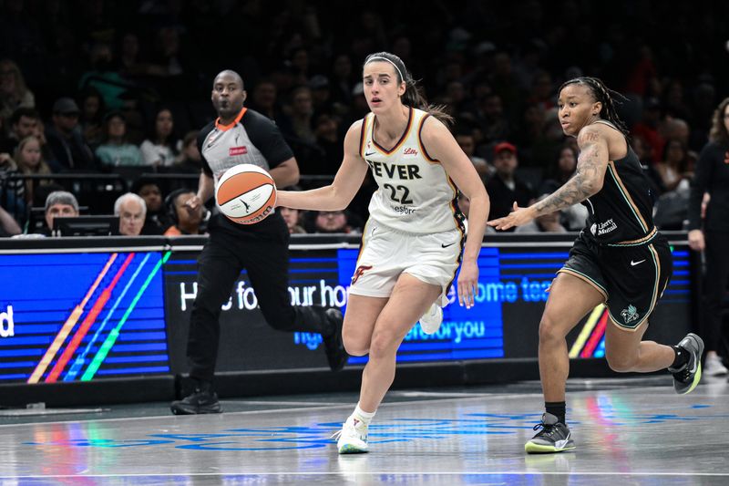 Apr 25, 2026; Brooklyn, NY, USA; Indiana Fever guard Caitlin Clark (22) dribbles past New York Liberty guard Ny'ceara Pryor (1) during the first half at Barclays Center. Mandatory Credit: John Jones-Imagn Images