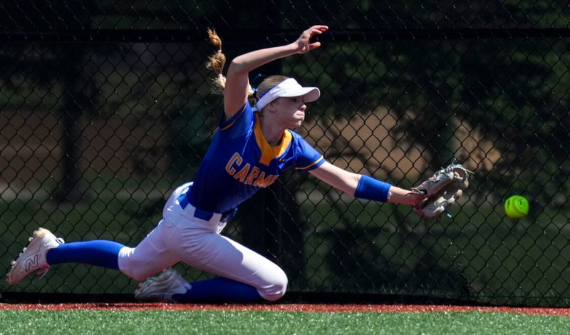 Carmel Greyhounds' Chloe Junkersfield (1) attempts to catch a fly ball during a Carmel Invitational game on Saturday, April 25, 2026, at Cherry Tree Softball Complex in Carmel.