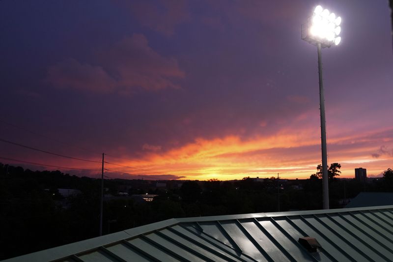 The sun sets during a college softball game between Tennessee and Alabama at Sherri Parker Lee Stadium in Knoxville, Tennessee, April 25, 2026.