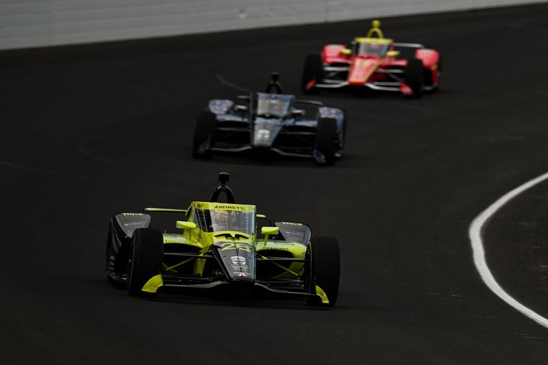 Will Power leads a group of drivers into a turn at Indianapolis Motor Speedway during Indy 500 open testing in April 2026.