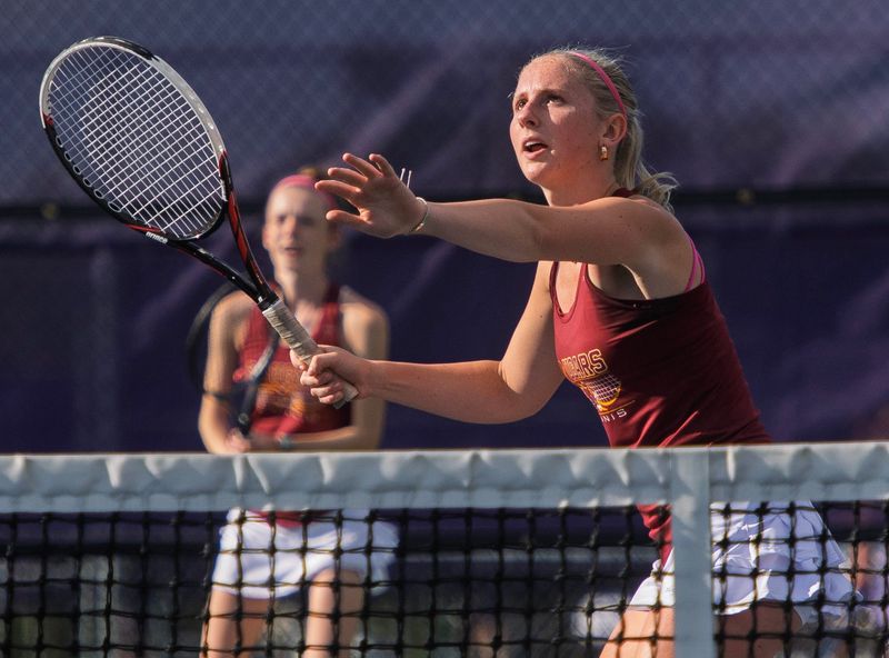 North's Oakley Yoder hits a return as parter Lilia McHaley looks on during their number one doubles match in the Bloomington North versus Bloomington South girl's tennis match at Bloomington High School South on Thursday, April 30, 2026.