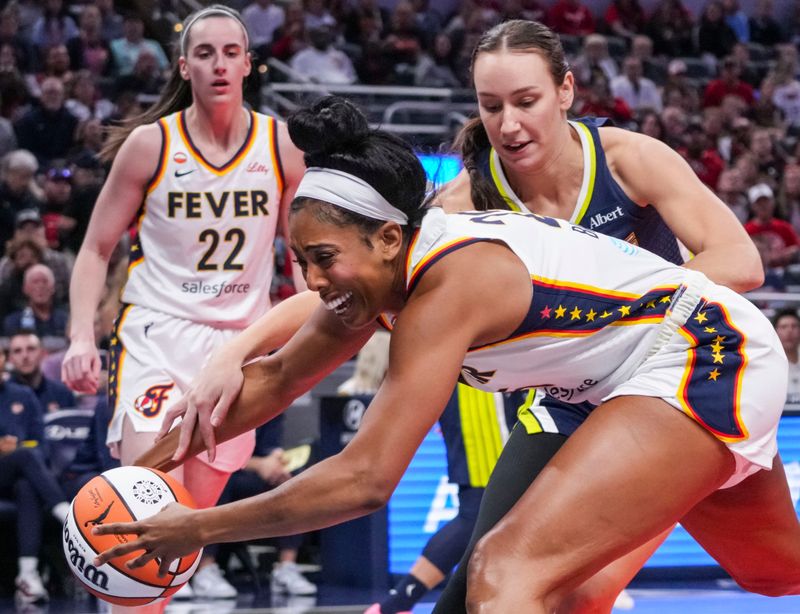 Indiana Fever forward Monique Billings (25) grabs the ball against Dallas Wings forward Alanna Smith (8) on Thursday, April 30, 2026, during the first half of a preseason game between the Indiana Fever and the Dallas Wings at Gainbridge Fieldhouse in Indianapolis.