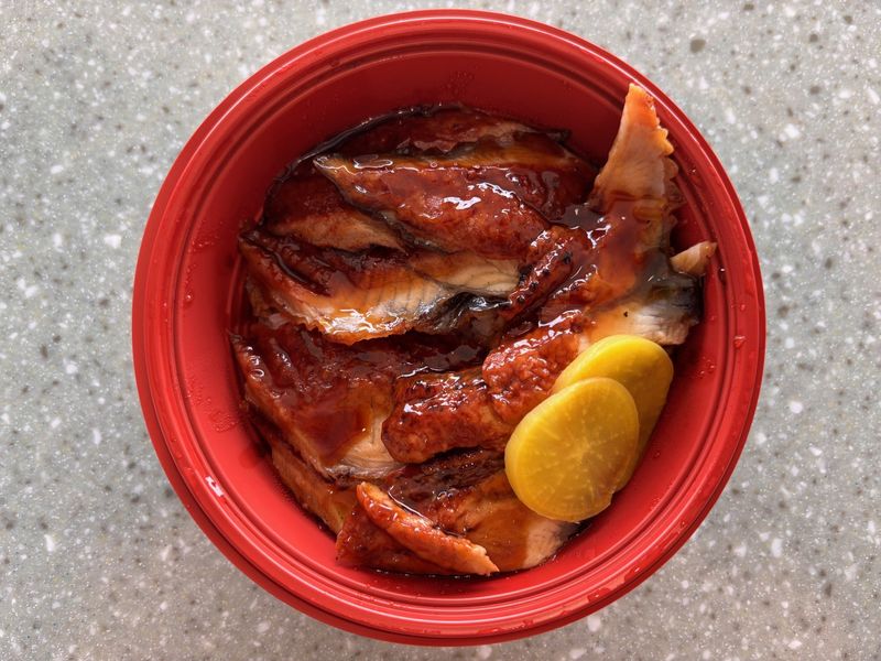 Unadon, a dish of grilled freshwater eel over rice, is among the to-go offerings at One World Market, 8466 Castleton Corner Drive. April 28, 2026
