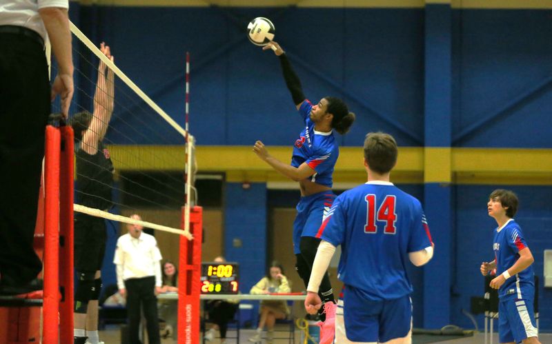 Junior Keyon Johnson spikes the ball during a South Bend Adams vs. Dekalb boys volleyball game Saturday, May 2, 2026, at Elkhart High School.