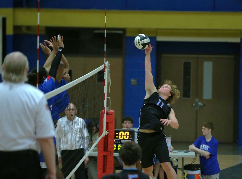 Junior Brody Uelk hits the ball over the net during a South Bend Saint Joseph vs. South Bend Adams boys volleyball game Saturday, May 2, 2026, at Elkhart High School.