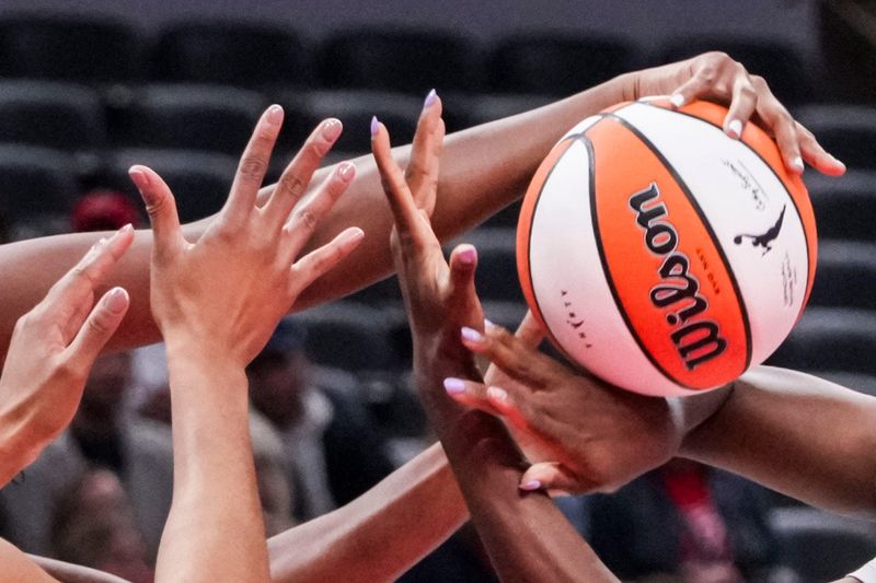Indiana Fever center-forward Aliyah Boston (7), Nigeria’s Pallas Kunaiyi (3) and Nigeria’s Nicole Enabosi (33) go for the ball Saturday, May 2, 2026, during the first half of a preseason game at Gainbridge Fieldhouse in Indianapolis.