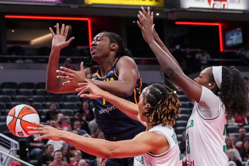 Indiana Fever forward Aliyah Boston (7) loses the ball against Nigeria’s Pallas Kunaiyi (3) and Nigeria’s Nicole Enabosi (33) on Saturday, May 2, 2026, during the first half of a preseason game at Gainbridge Fieldhouse in Indianapolis.