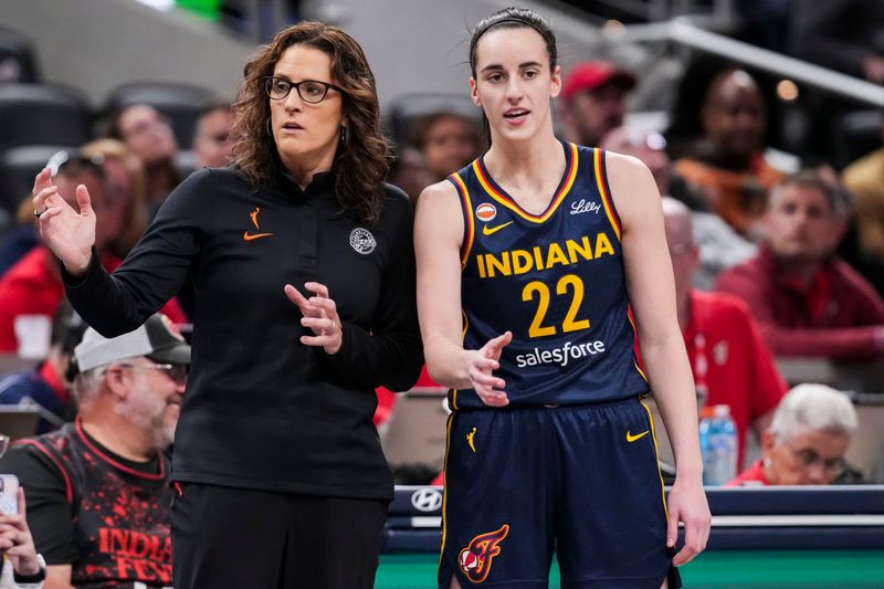 Indiana Fever head coach Stephanie White talks with Indiana Fever guard Caitlin Clark (22) on Saturday, May 2, 2026, during the first half of a preseason game at Gainbridge Fieldhouse in Indianapolis.