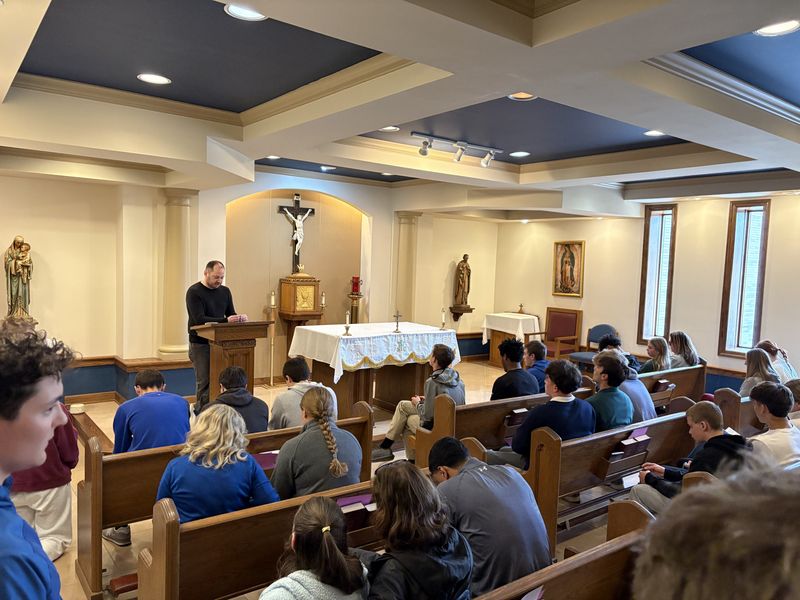 Matt Sobieralski (front) leads a rosary for high school basketball assistant coach Brian Foster, who is in critical condition after a car accident May 1, Sunday, May 3, 2026, at Mishawaka Marian High School.